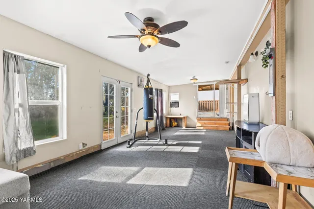 a view of a porch with a table and chairs