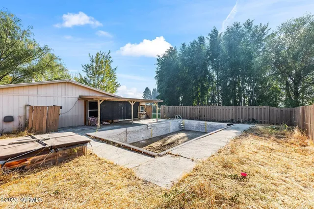 a view of outdoor space with swimming pool and green space