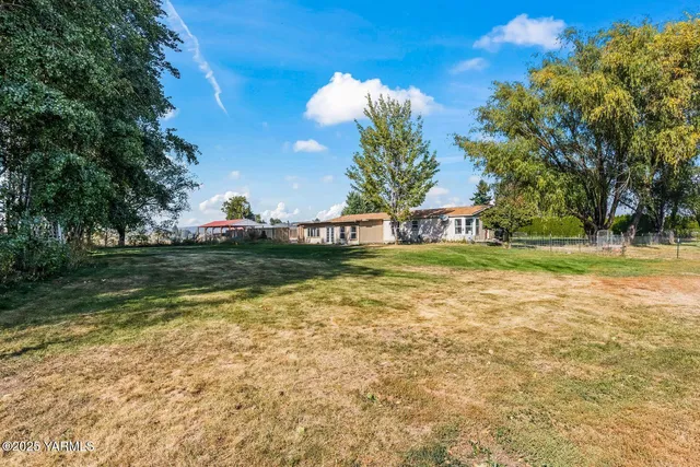 an aerial view of a residential houses with outdoor space