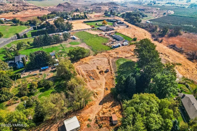 an aerial view of residential houses with outdoor space and street view
