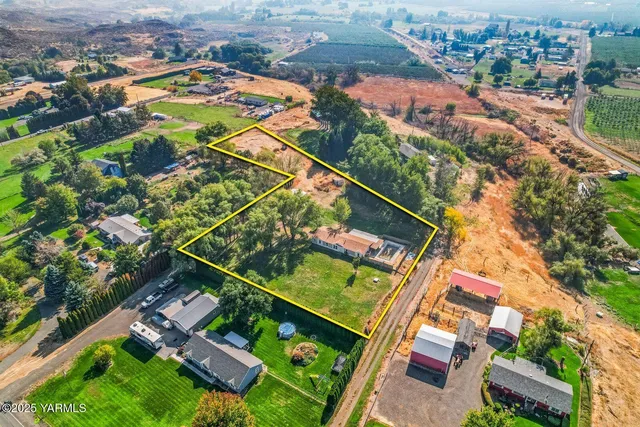 an aerial view of residential houses with yard