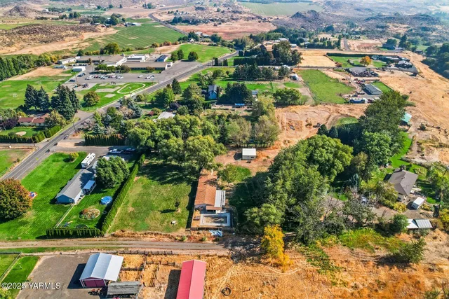 an aerial view of residential houses with outdoor space