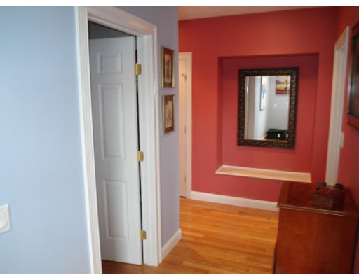 23 Bird Hill Road Lexington, MA 02421 - Photo 13 of 30 a view of a hallway with wooden floor and a mirror
