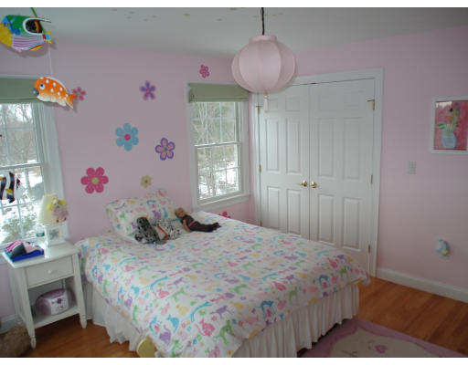 23 Bird Hill Road Lexington, MA 02421 - Photo 17 of 30 a bedroom with a bed and a chandelier