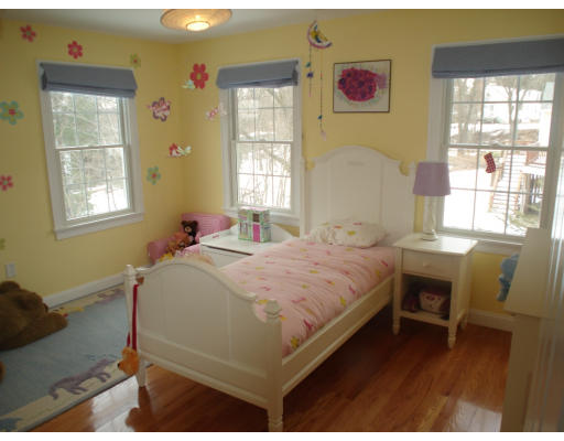 23 Bird Hill Road Lexington, MA 02421 - Photo 19 of 30 a bed sitting in a bedroom next to a window