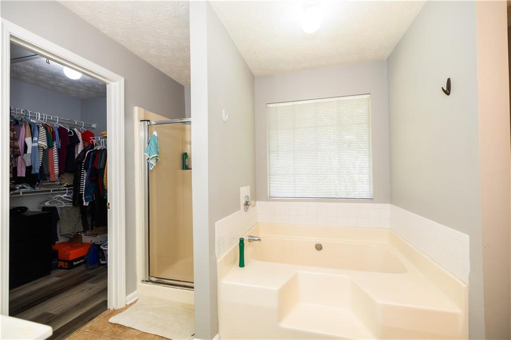 599 Rivulett Court Lawrenceville, GA 30043 - Photo 13 of 31 a bathroom with a bathtub and a shower