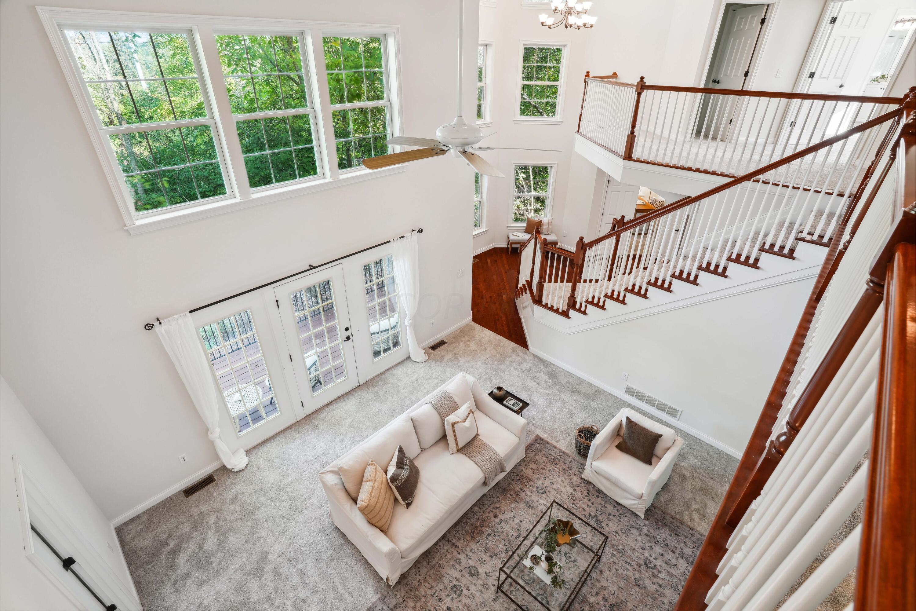 10403 Liberty Road Powell, OH 43065 - Photo 17 of 76 Bright and airy Two Story Great Room with marble gas fireplace, freshly painted & new carpet in July 2024! French doors to front deck overlooking the pond!