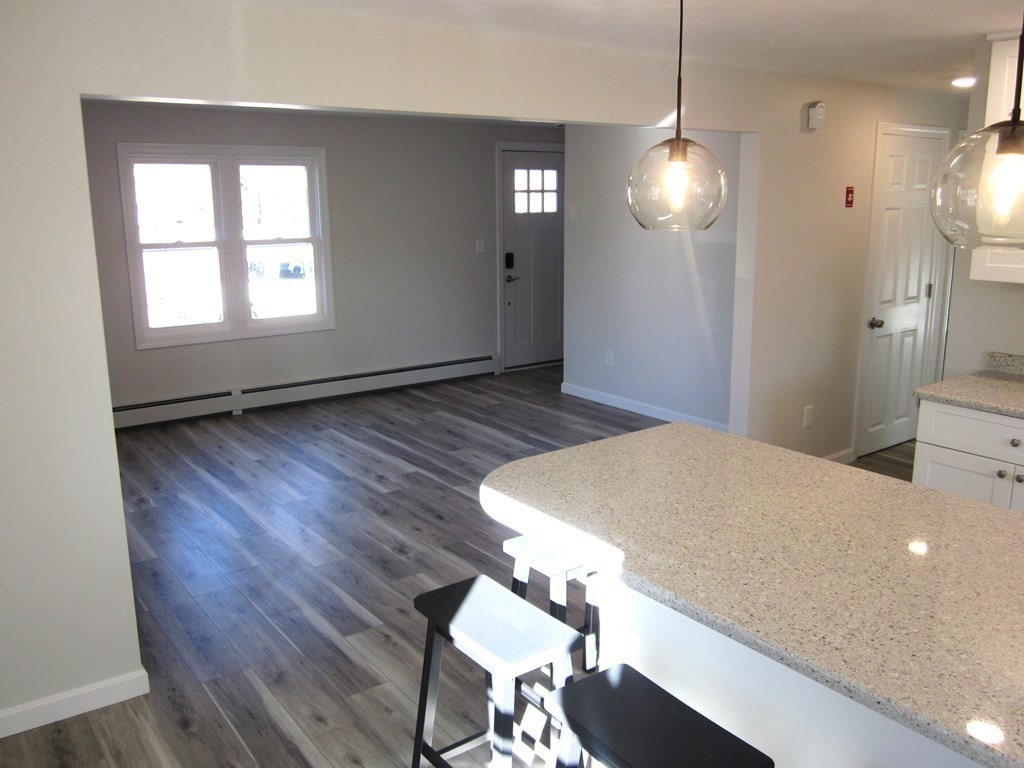 6 James Street Webster, MA 01570 - Photo 11 of 37 a bedroom with a bed and a chandelier