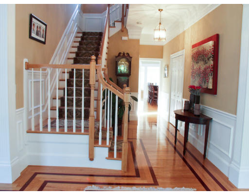 532 Lexington Road Concord, MA 01742 - Photo 3 of 20 a view of a hallway with wooden floor and staircase