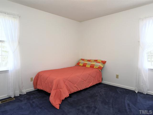 706 Young Road Angier, NC 27501 - Photo 11 of 25 a bed sitting in a room next to a window