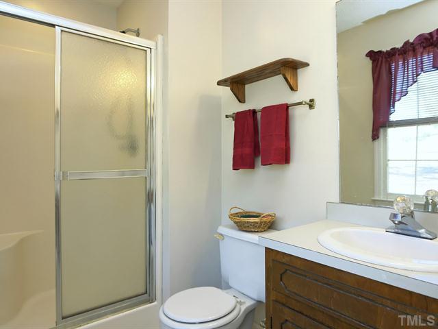 706 Young Road Angier, NC 27501 - Photo 12 of 25 a bathroom with a sink vanity mirror and toilet