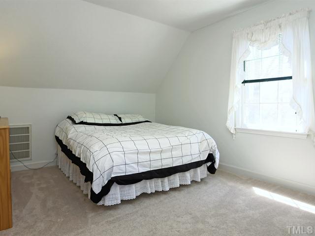 706 Young Road Angier, NC 27501 - Photo 13 of 25 a bedroom with a bed and window