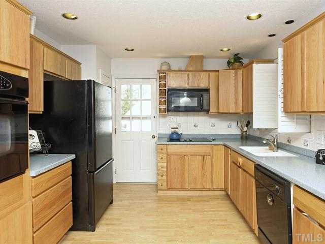 706 Young Road Angier, NC 27501 - Photo 4 of 25 a kitchen with stainless steel appliances granite countertop a refrigerator stove microwave and sink