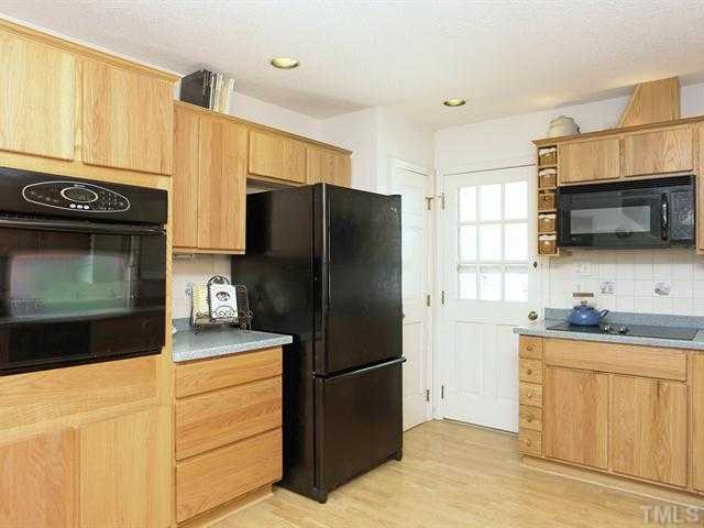 706 Young Road Angier, NC 27501 - Photo 5 of 25 a kitchen with a refrigerator sink and microwave