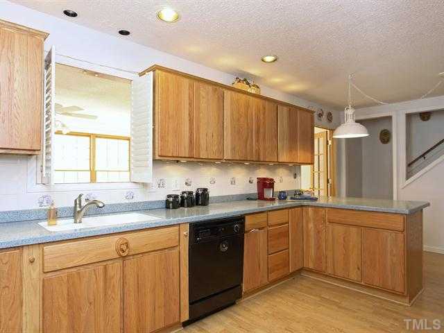 706 Young Road Angier, NC 27501 - Photo 6 of 25 a kitchen with a sink a window and cabinets
