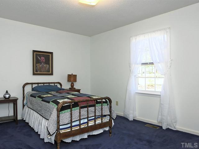 706 Young Road Angier, NC 27501 - Photo 9 of 25 a bedroom with a bed and window