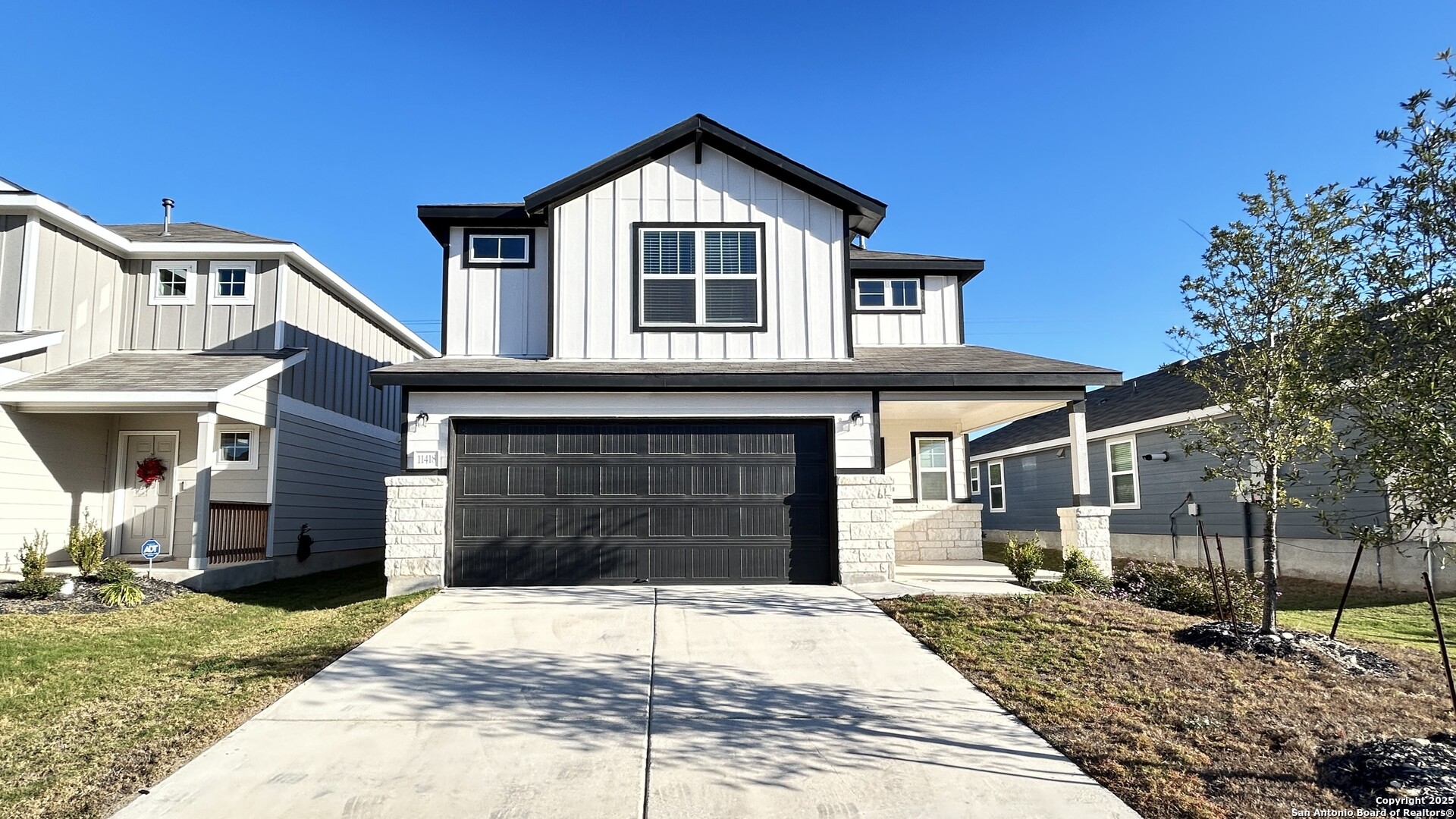 a front view of a house with a yard and garage