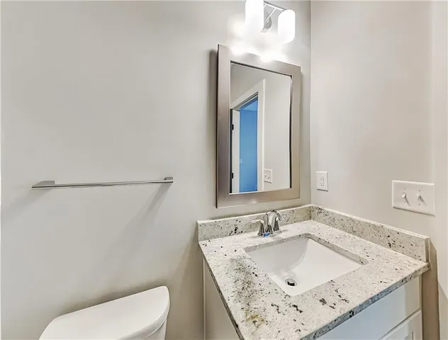 a bathroom with a sink toilet and mirror