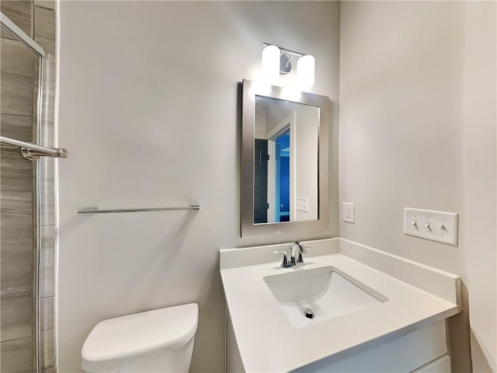 2038 Rockledge Road Northeast Atlanta, GA 30324 - Photo 15 of 21 a bathroom with a sink toilet and mirror