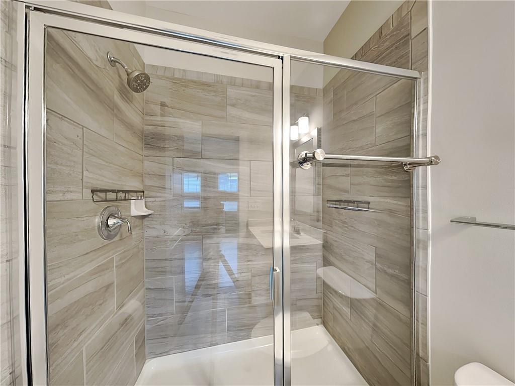2038 Rockledge Road Northeast Atlanta, GA 30324 - Photo 16 of 21 a bathroom with a glass shower door