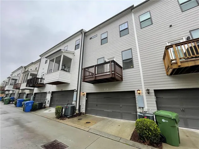 a front view of a house with plants