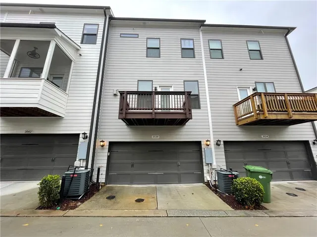 a front view of a house with plants