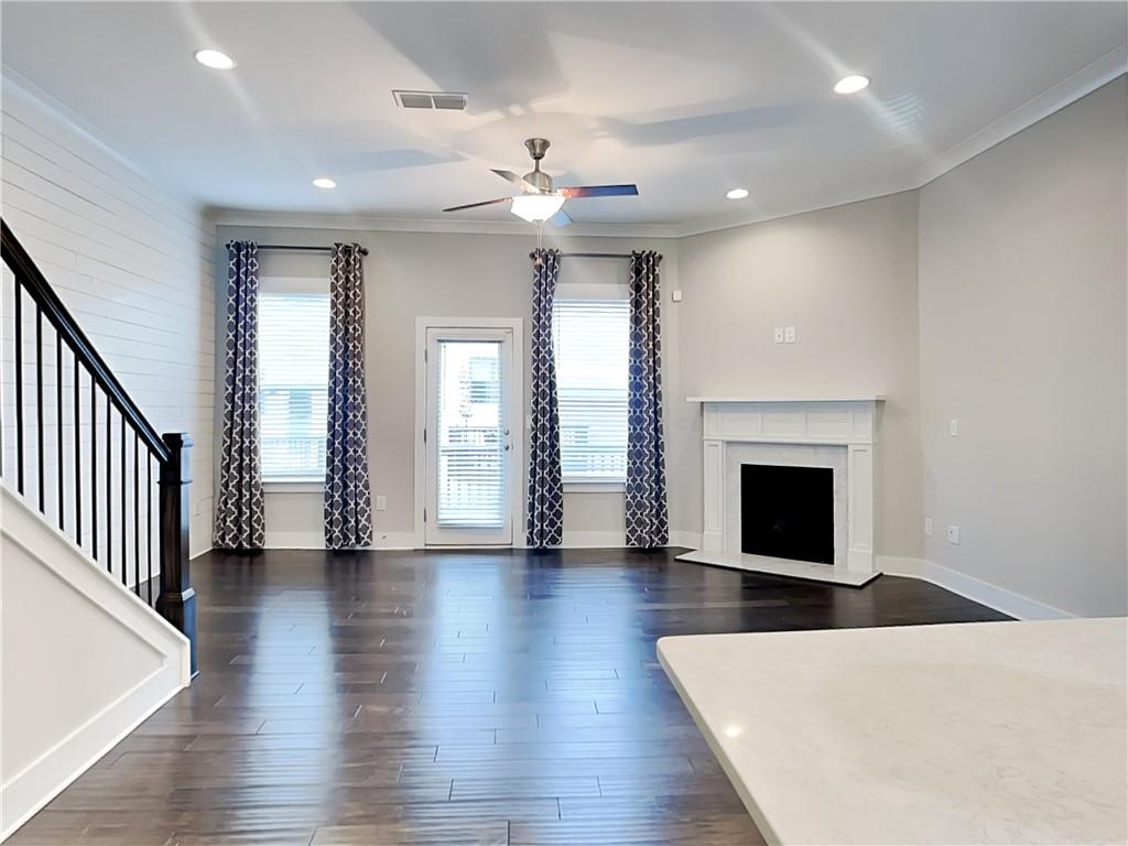 2038 Rockledge Road Northeast Atlanta, GA 30324 - Photo 4 of 21 an empty room with wooden floor fireplace and windows
