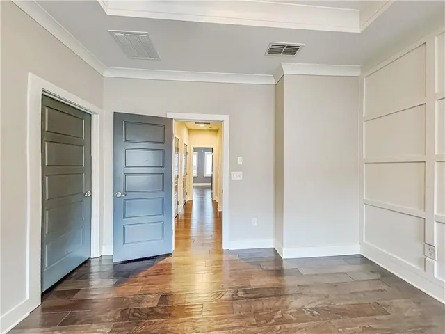 an empty room with closet and wooden floor