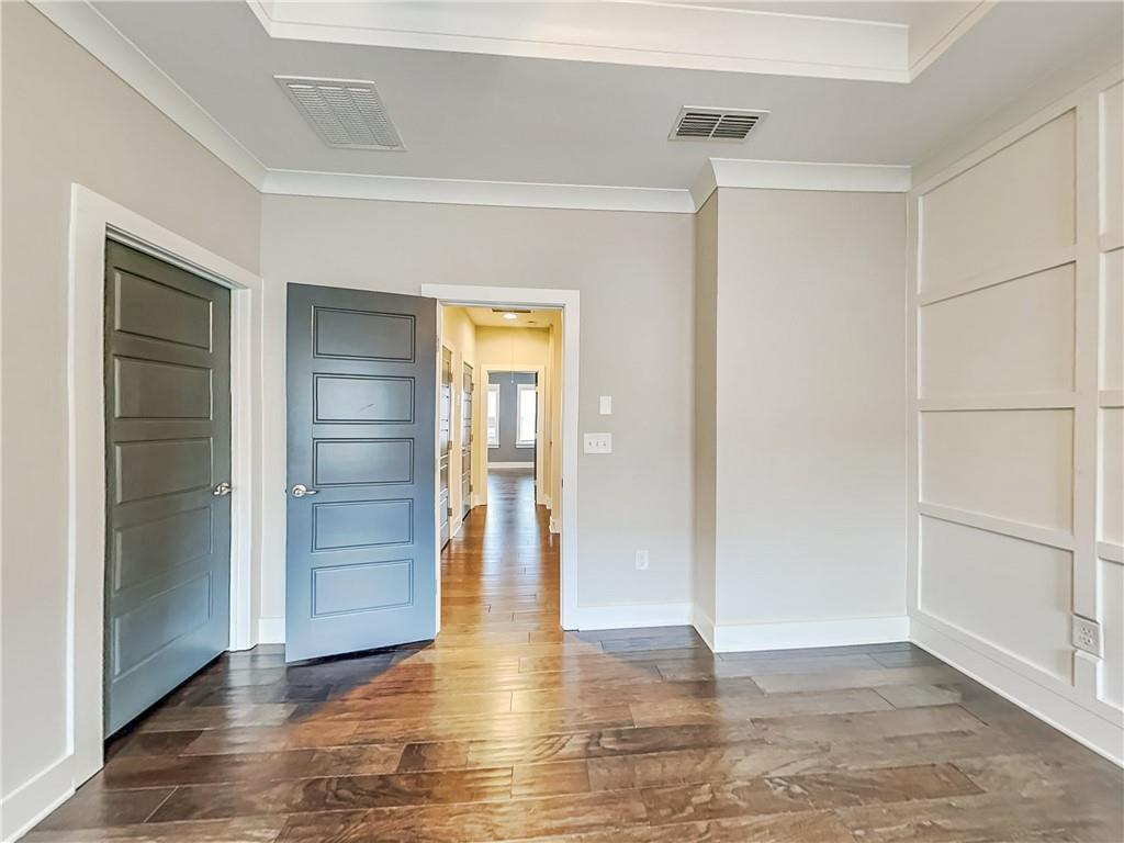 2038 Rockledge Road Northeast Atlanta, GA 30324 - Photo 8 of 21 an empty room with closet and wooden floor