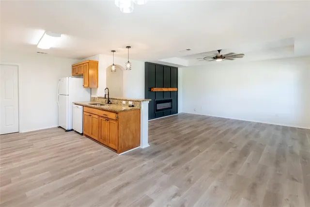 a view of kitchen with cabinets and wooden floor