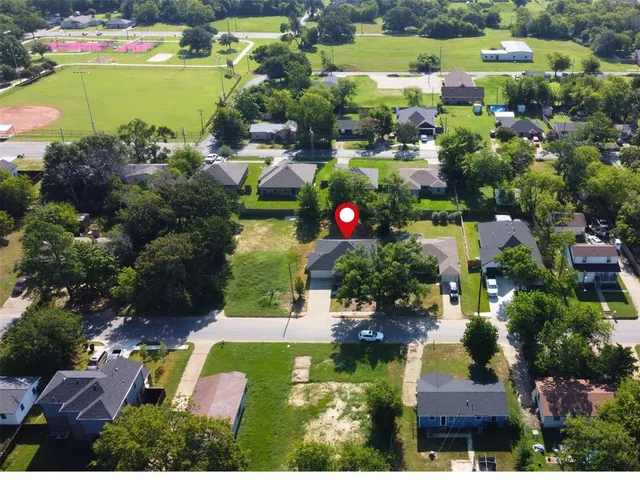 an aerial view of residential houses with outdoor space and swimming pool