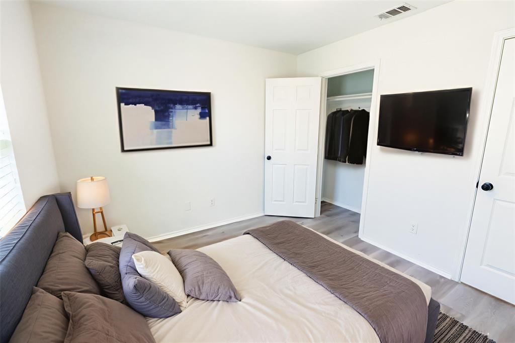 413 Bethlehem Street Terrell, TX 75160 - Photo 7 of 16 a bedroom with a bed and a flat screen tv