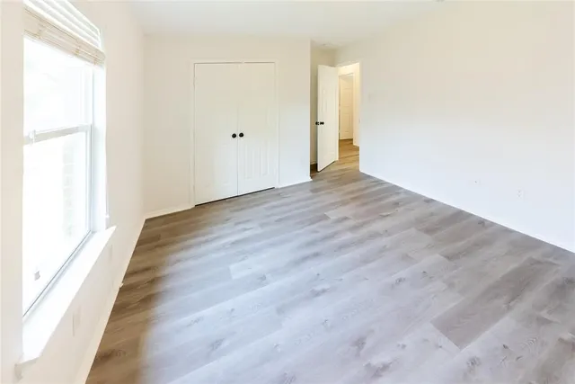 a view of an empty room and wooden floor