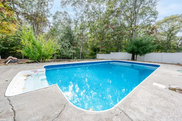 a view of a swimming pool with a yard