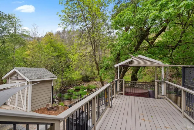 a view of deck with furniture and trees