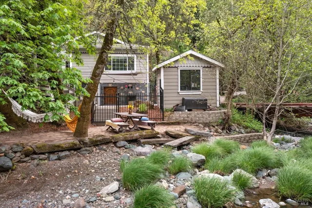 a front view of house with yard and green space