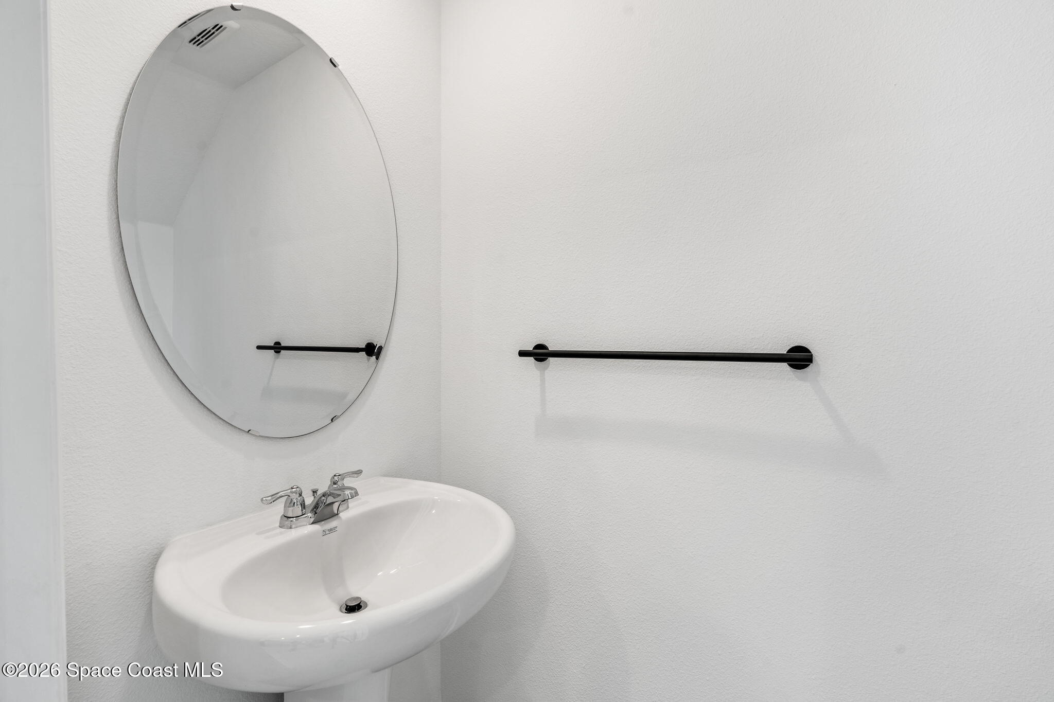 2117 Topsail Way Rockledge, FL 32955 - Photo 16 of 16 a bathroom with a sink and mirror