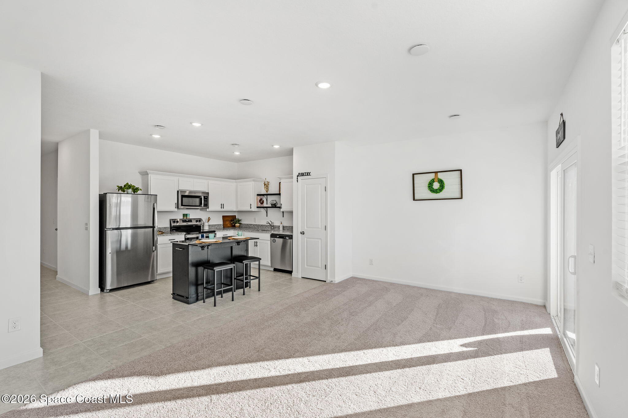 2117 Topsail Way Rockledge, FL 32955 - Photo 8 of 16 a view of a kitchen with furniture and stainless steel appliances