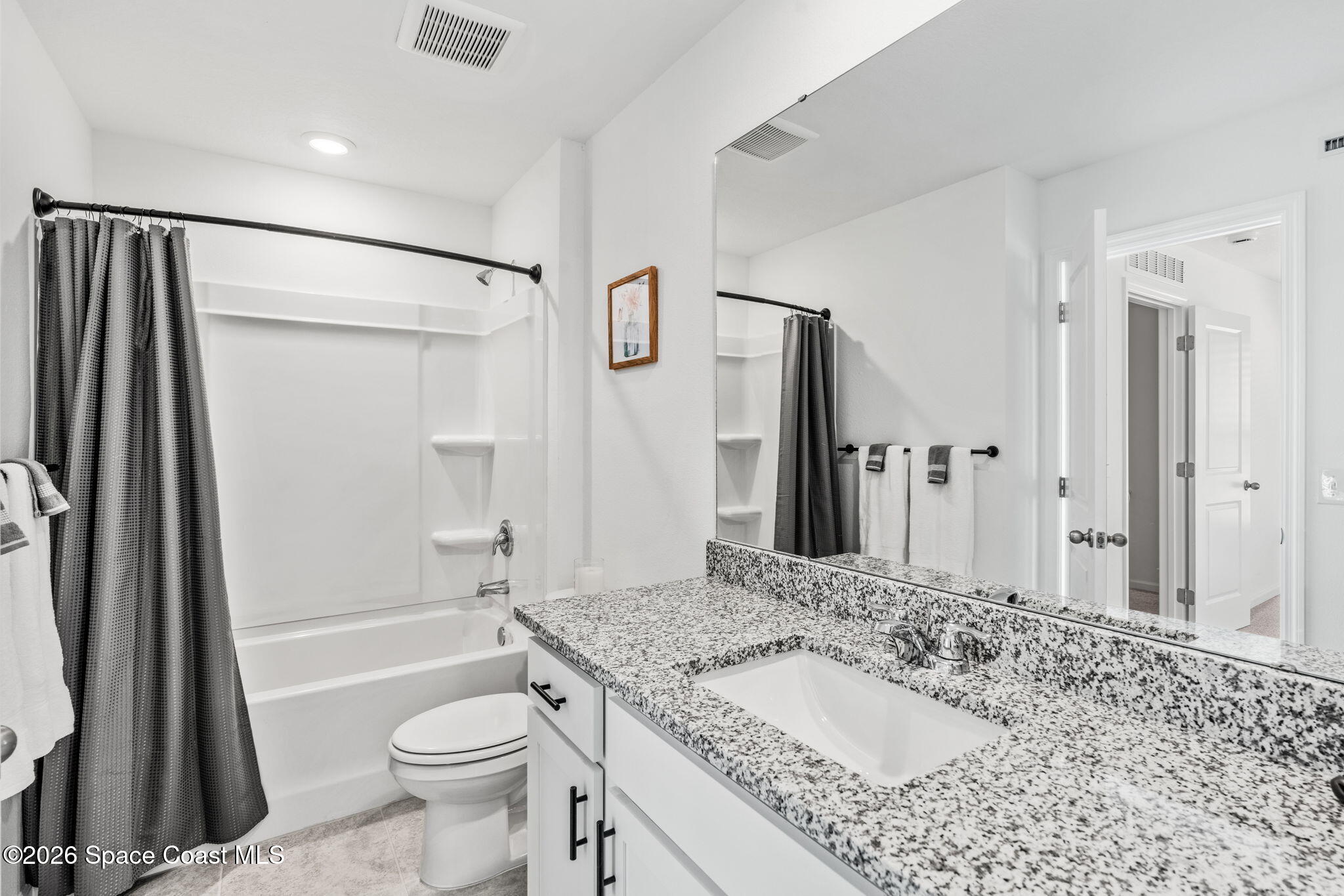 2117 Topsail Way Rockledge, FL 32955 - Photo 9 of 16 a bathroom with a granite countertop sink toilet and shower