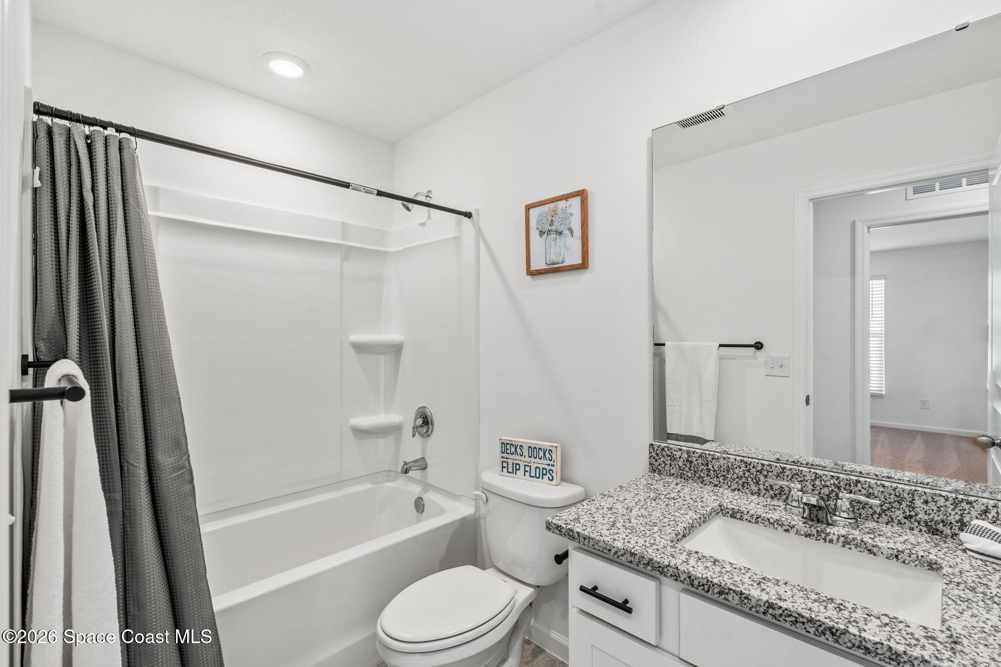 2117 Topsail Way Rockledge, FL 32955 - Photo 10 of 16 a bathroom with a granite countertop sink toilet and shower