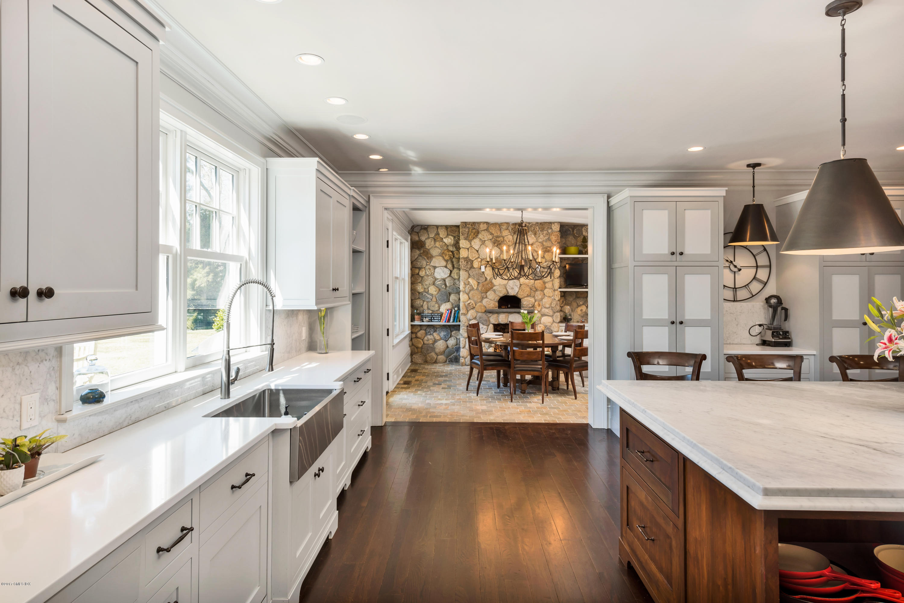 136 Parsonage Road Greenwich, CT 06830 - Photo 11 of 35 a view of a large kitchen with kitchen island a large window a sink and living room view