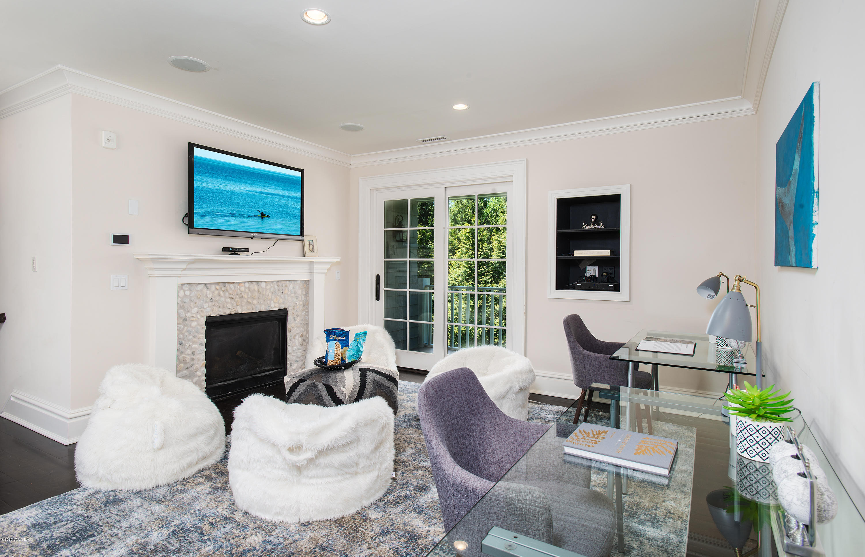136 Parsonage Road Greenwich, CT 06830 - Photo 19 of 35 a living room with furniture a fireplace and a flat screen tv