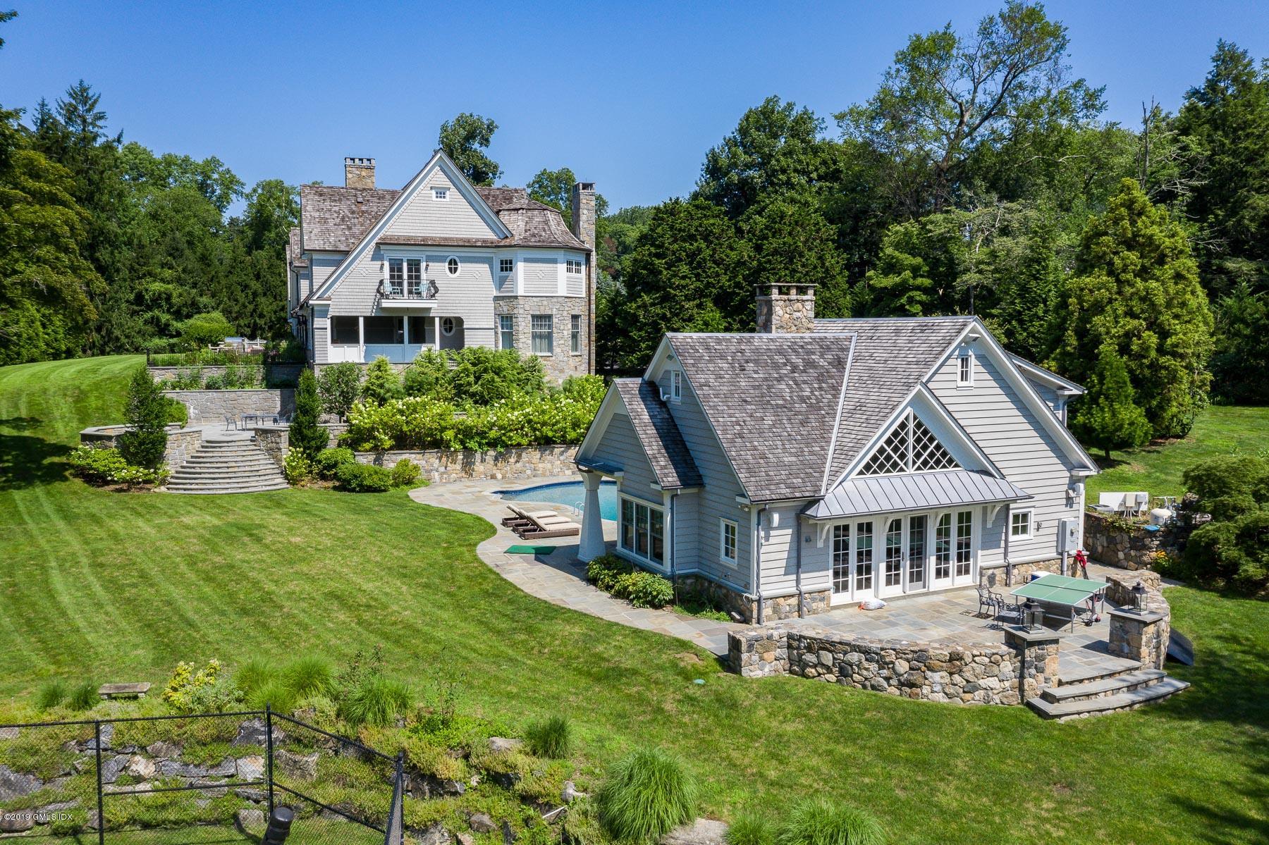 136 Parsonage Road Greenwich, CT 06830 - Photo 23 of 35 a front view of a house with a garden