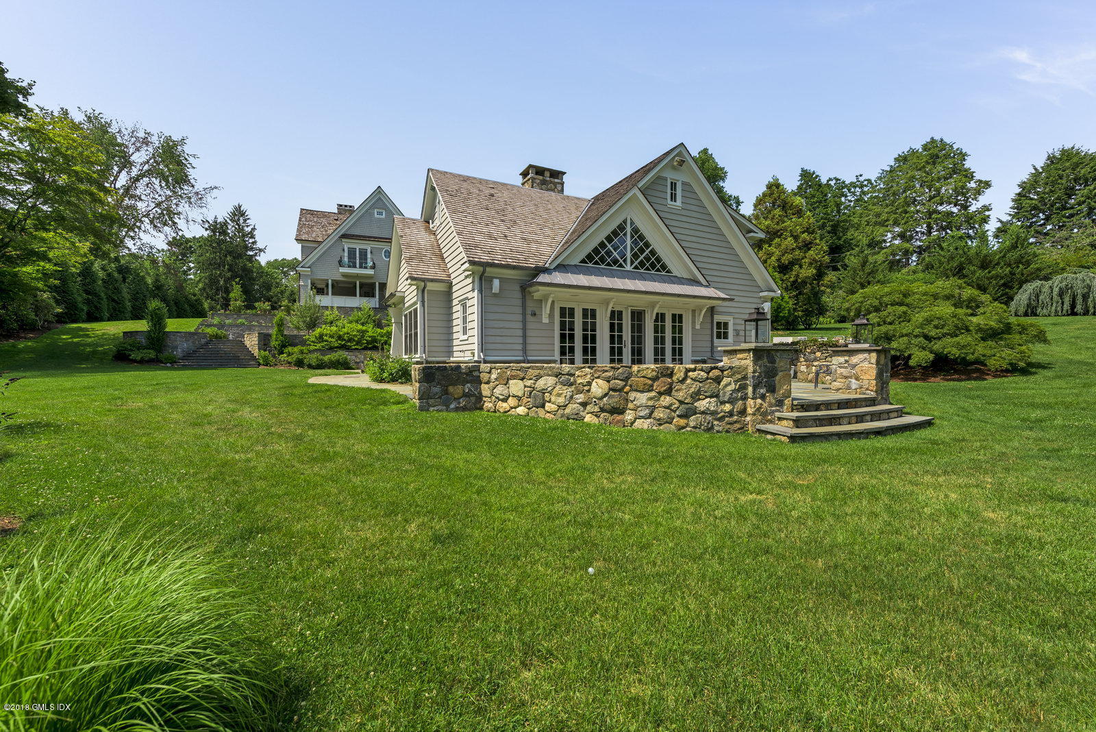 136 Parsonage Road Greenwich, CT 06830 - Photo 30 of 35 a front view of a house with a yard