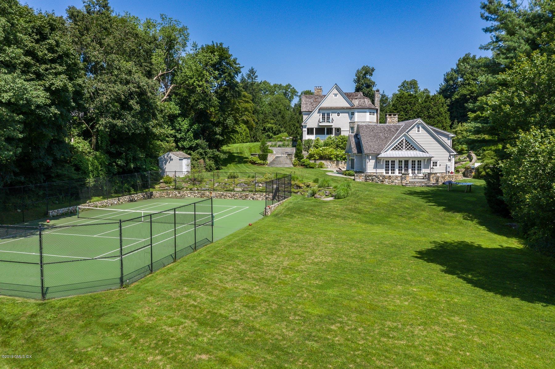 136 Parsonage Road Greenwich, CT 06830 - Photo 31 of 35 a view of a house with a yard and potted plants