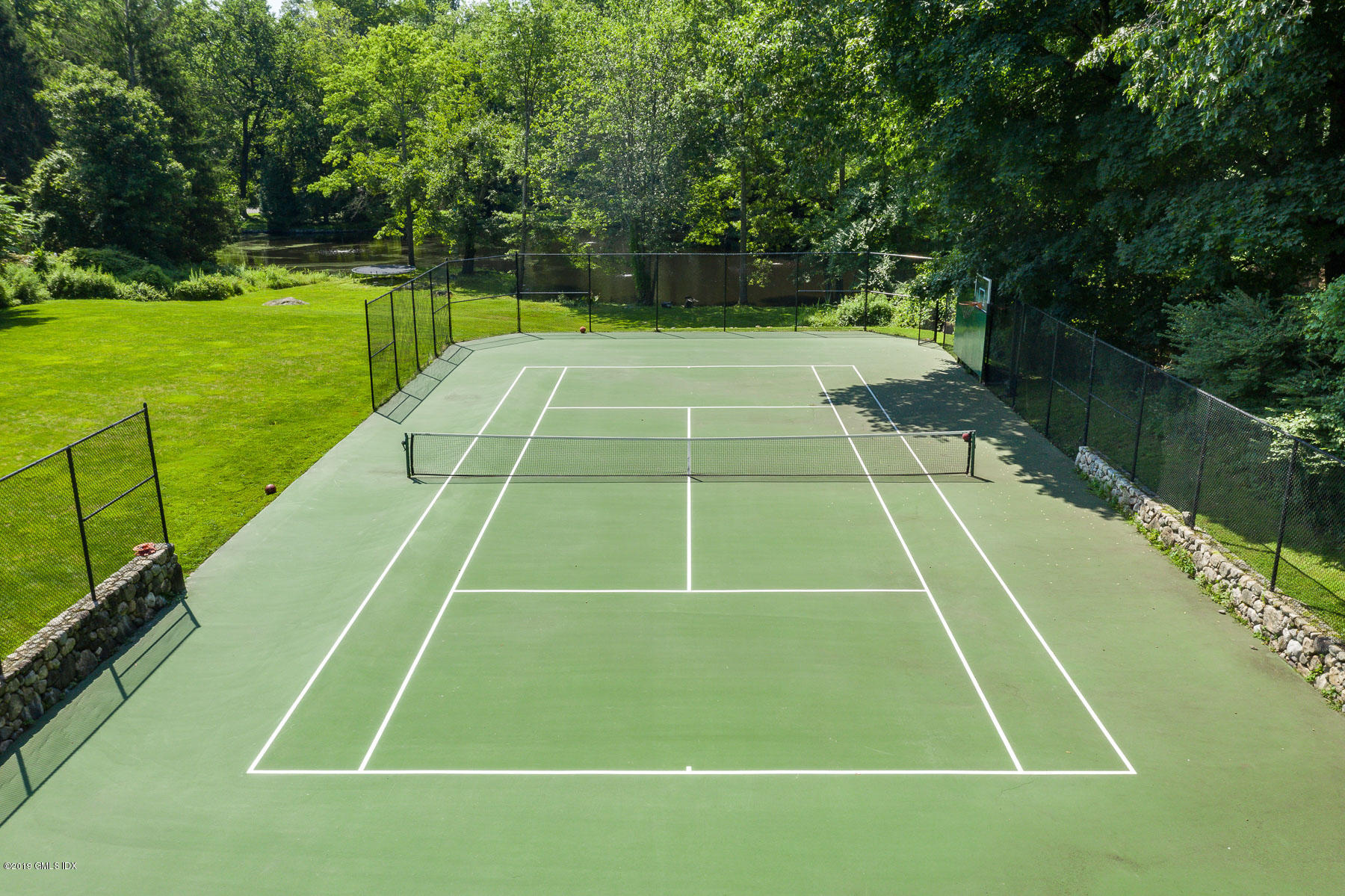 136 Parsonage Road Greenwich, CT 06830 - Photo 32 of 35 a tennis court that has tennis net