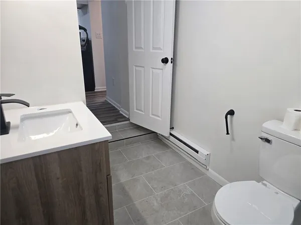 a bathroom with a sink mirror vanity and toilet