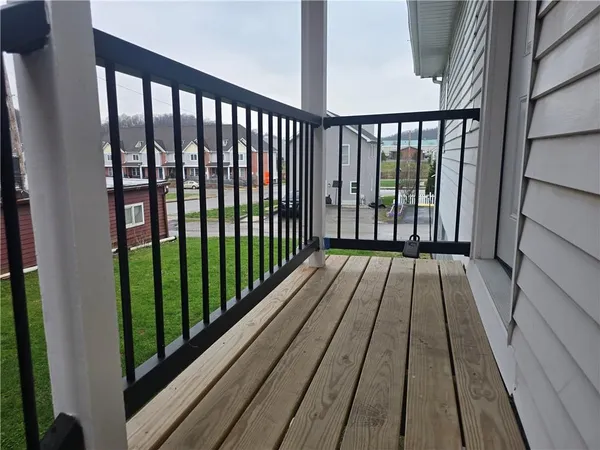 a view of balcony with wooden floor