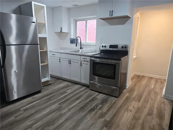 a kitchen with granite countertop a stove and a refrigerator