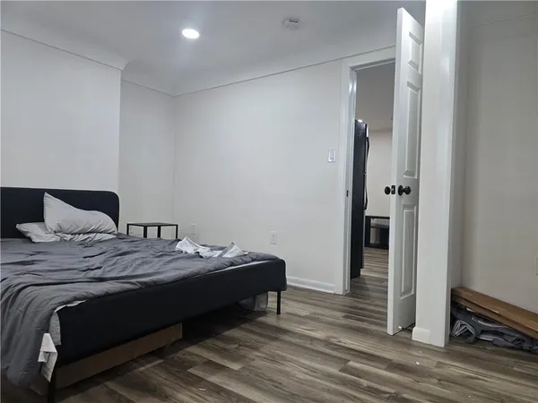 a bedroom with a bed and a mirror